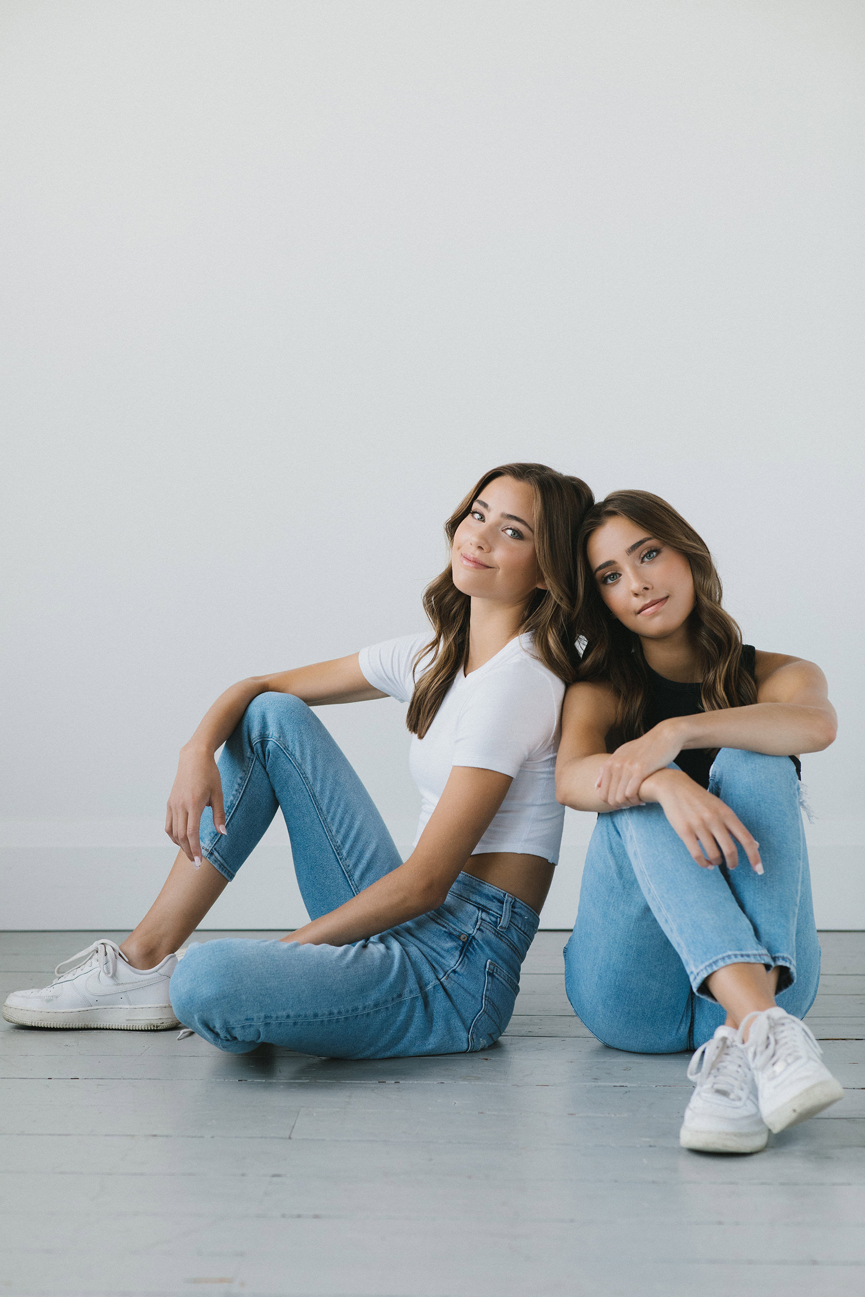 A studio portrait of twin sisters photographed downtown Whitby to mark their graduation.